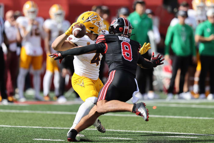 Nov 4, 2023; Salt Lake City, Utah, USA; Arizona State Sun Devils running back Cameron Skattebo (4) is pressured by Utah Utes safety Cole Bishop (8) in the third quarter at Rice-Eccles Stadium. Mandatory Credit: Rob Gray-USA TODAY Sports  